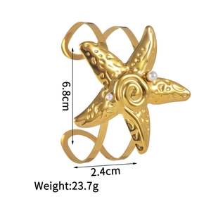 Detail of gold starfish bangle with pearl accents showing dimensions 6.8cm and 2.4cm