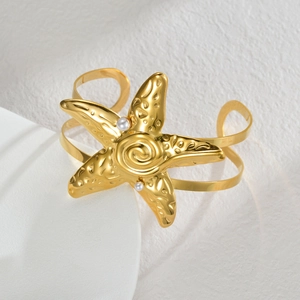 Gold ocean starfish cuff bracelet with elegant pearl accents and textured metal finish