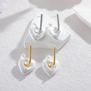 Elegant heart-shaped pearl earrings in gold and silver finish with textured surface