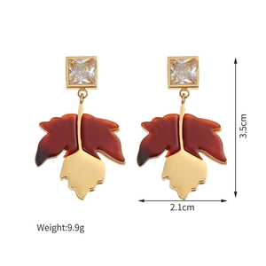 Detailed close-up of maple leaf earrings with square zircon and 18K gold plating