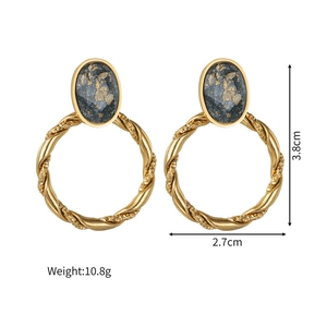 Macro detail of vintage twisted gold earrings with black agate and dimensions info
