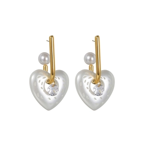 Elegant gold heart earrings with white pearls and crystal centers on a white background
