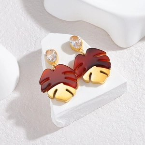 Tropical style monstera leaf drop earrings with brown resin and golden metal base