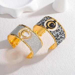 Wide stainless steel bangles with leopard print and silver glitter crescent designs