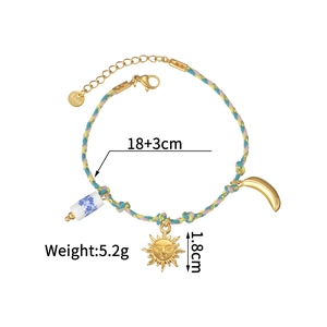 Detail of woven rope bracelet with gold sun and moon charms including size parameters