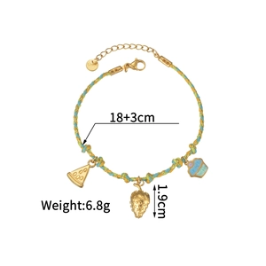 Detail of woven rope bracelet with watermelon and strawberry pendants and lobster clasp