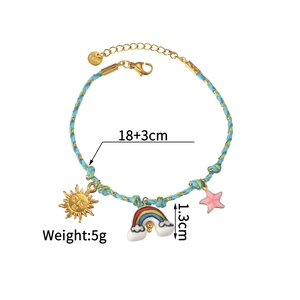 Close-up of woven bracelet featuring enamel sun, rainbow and starfish charms on 18K gold chain