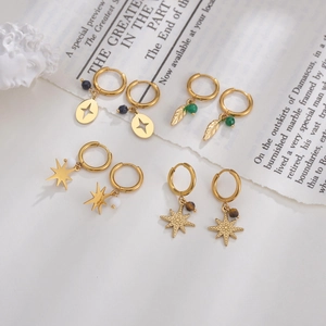 Detailed close-up of 14K gold plated hoop earrings with bohemian star and bead charms