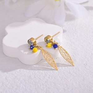 Detailed view of 14K gold-plated leaf earrings with blue and yellow beads and crystals