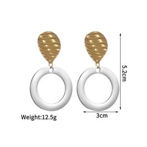 Detail of two-tone geometric drop earrings with 5.2cm length and 3cm silver ring width