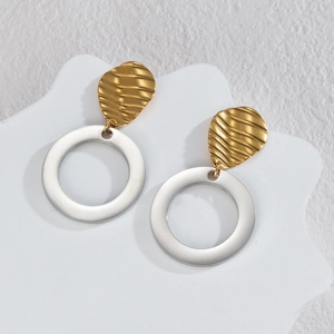 Minimalist geometric earrings with golden ripple studs and silver circular rings