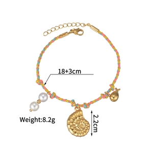 Detail of woven ocean bracelet featuring a gold starfish and shell pendant with pearls