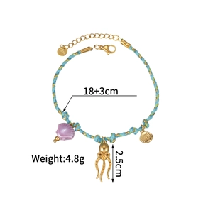 Macro detail of nautical woven bracelet with gold octopus charm and S.Steel clasp