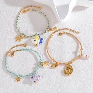 Handmade ocean-themed colorful rope bracelets with 18K gold starfish and shell charms