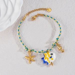 Handmade woven ocean bracelet with 18k gold seahorse and starfish charms for women