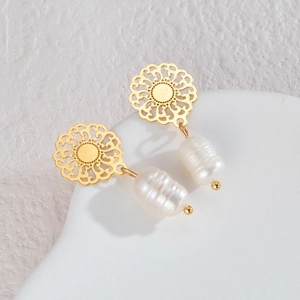 Elegant gold flower stud earrings with baroque pearl drop in a minimalist french style