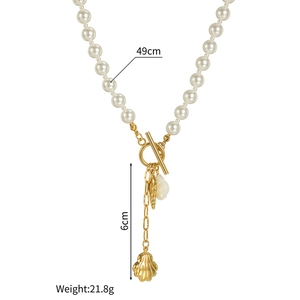 Detail of pearl necklace showing 49cm length and 6cm gold seashell charms