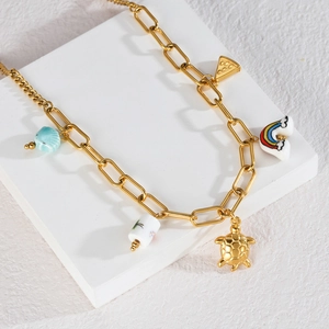 Gold link chain necklace with ceramic pendants like sea turtle and watermelon