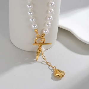 Elegant pearl necklace with golden shell pendant and OT buckle on white display stand