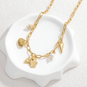 Collier doré 18 carats avec pendentifs coquillage et étoile de mer sur plateau