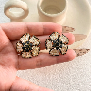 Exquisite gold floral stud earrings with black and clear cubic zirconia stones