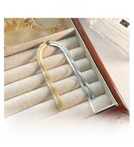 Detail of luxury gold and silver snake chain bracelets with inlaid sparkling crystals