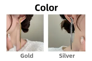 Close-up of dangling multi-chain tassel earrings in silver and gold diamond finishes