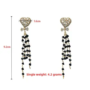 Detail of heart stud earrings with black bead tassels and crystal bow dimensions