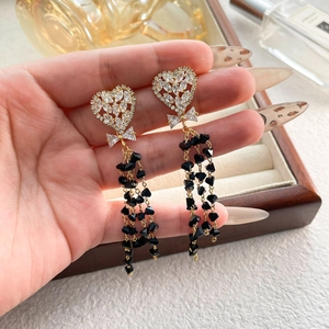 Elegant heart studs with black crystal long tassels and golden bow accents for women