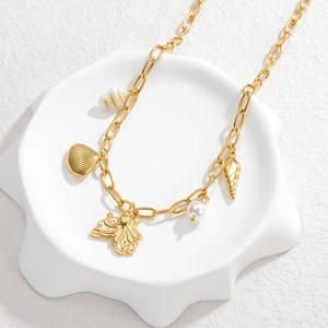 Gouden oceaan ketting met hanger van octopus en schelp plus een witte parel accent