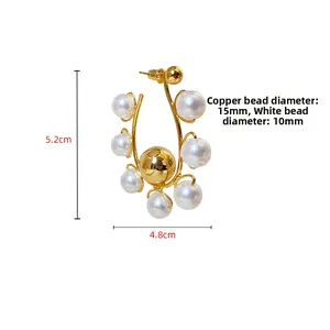 Detailed size view of U-shaped gold bead and white pearl earrings, 5.2cm x 4.8cm