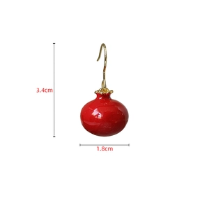 Detail view of red pomegranate earrings with dimensions 1.8cm wide and 3.4cm high