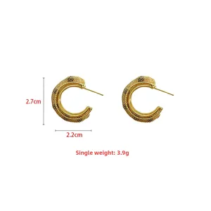 Detail view of gold C-shaped mesh earrings showing 2.7cm height and 2.2cm width dimensions