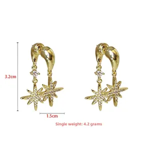 Detail view of gold star earrings with cubic zirconia, height 3.2cm and width 1.5cm