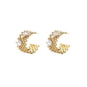 Detail of gold C-shaped hoop earrings with micro-bead texture and clear cubic zirconia