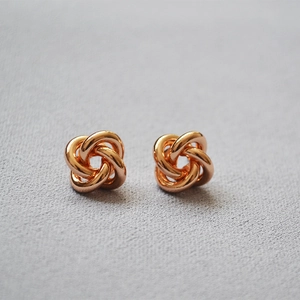Elegant gold knot flower stud earrings with polished metallic finish for women