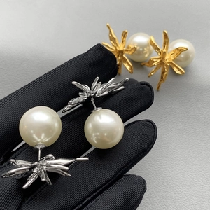 Modern geometric metal flower pearl earrings with an artistic irregular flow design