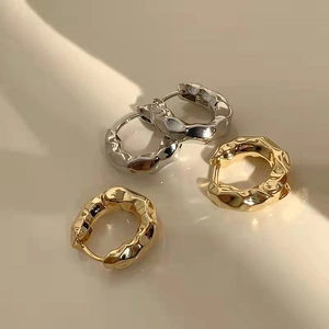 Minimalist geometric wave earrings in gold and silver finish with lava texture