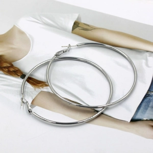 Macro shot of large polished S925 sterling silver hoop earrings with high-gloss finish