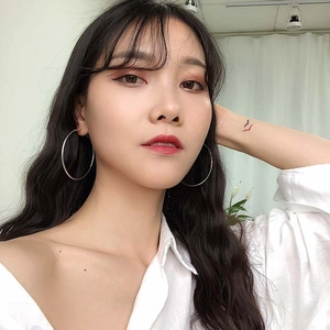 Minimalist S925 sterling silver hoop earrings shown on female model for modern style