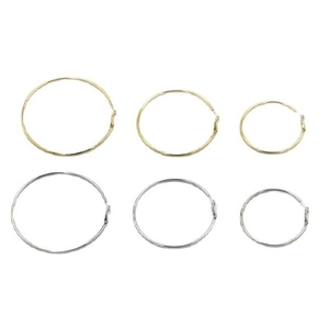 Set of large minimalist hoop earrings in gold and silver finishes across three sizes