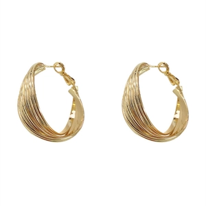 Thick golden C-shaped hoop earrings featuring a sophisticated twisted weave texture