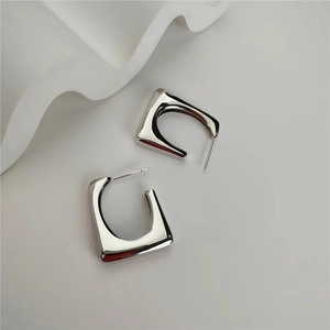 Minimalist geometric square U-shaped silver earrings with polished metallic finish
