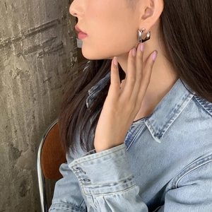 Polished silver geometric square hoop earrings for women shown on model for a trendy look