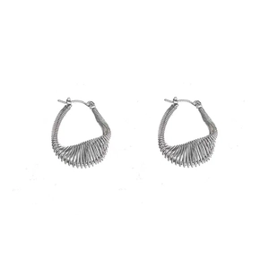 Minimalist silver spring coiled hoop earrings with industrial texture for women