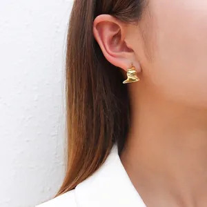 S925 silver needle geometric irregular gold earrings worn by a model in soft light