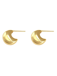Close-up of chunky gold crescent hoop earrings with polished reflective finish