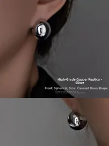 Detailed view of silver minimalist dome earrings showing spherical and crescent profiles