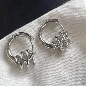 Minimalist geometric silver spiral hoop earrings with intertwined circular charms