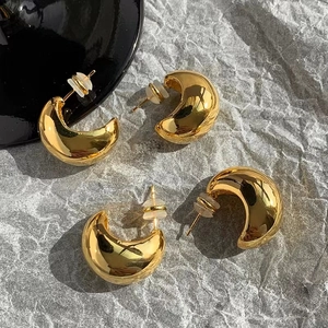 Minimalist high-polished gold crescent earrings with glossy finish and modern design